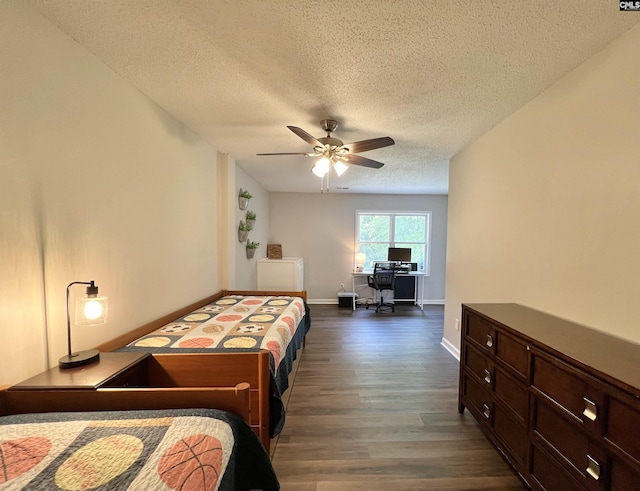 bedroom with a textured ceiling, ceiling fan, and dark wood-type flooring