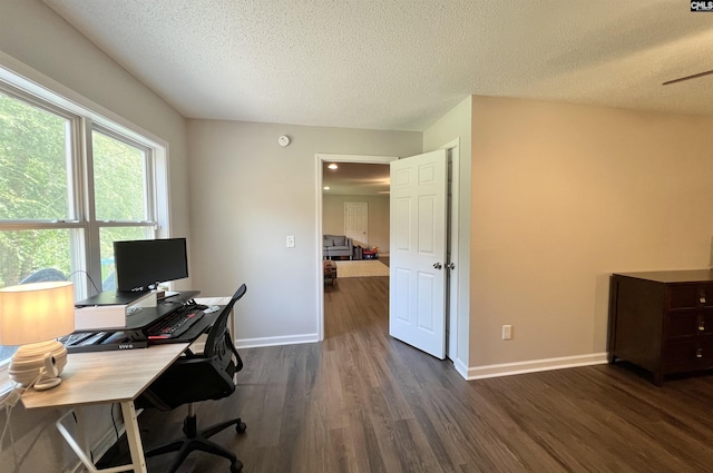 office area with dark hardwood / wood-style flooring and a textured ceiling