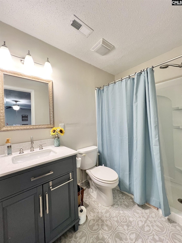 bathroom featuring ceiling fan, a shower with curtain, a textured ceiling, toilet, and vanity