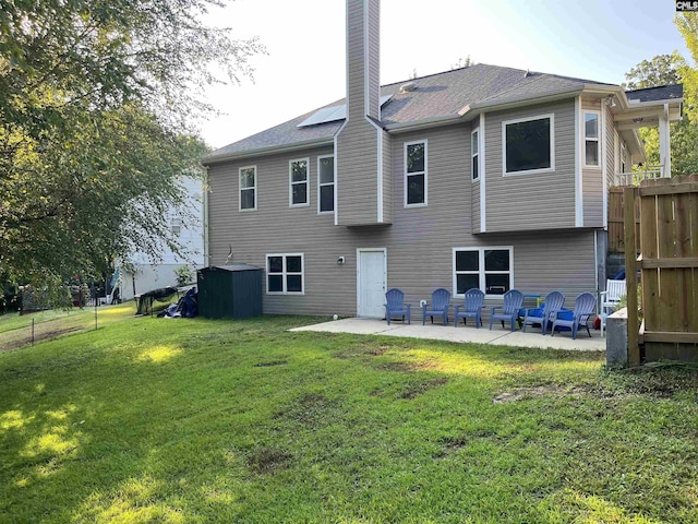 back of house featuring a yard and a patio