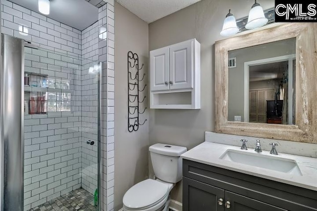 bathroom featuring vanity, toilet, and an enclosed shower