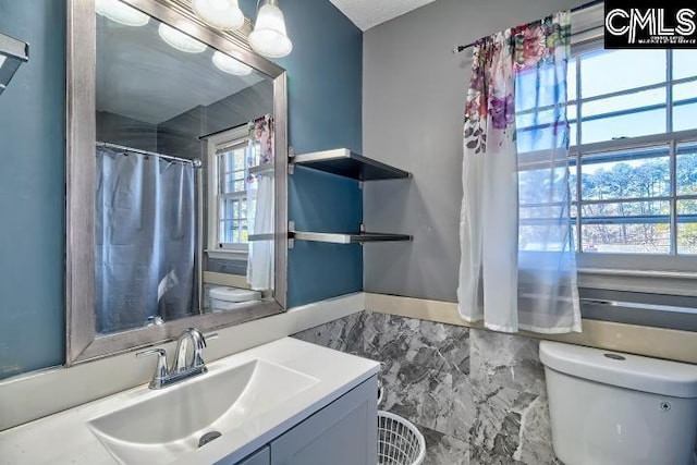 bathroom featuring vanity and toilet