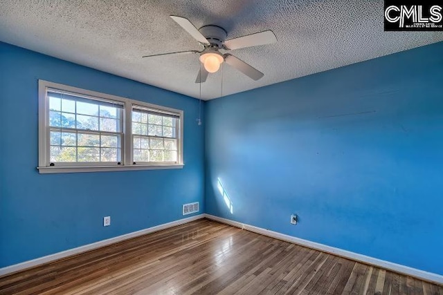 spare room featuring wood-type flooring, a textured ceiling, and ceiling fan