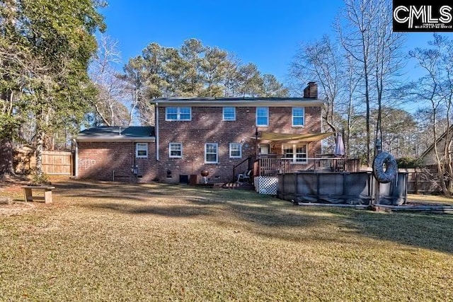 rear view of house with a swimming pool side deck, central AC, and a lawn