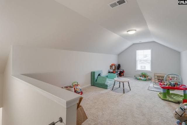 playroom with carpet floors and vaulted ceiling