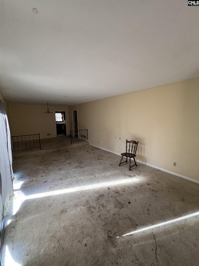 empty room featuring a chandelier