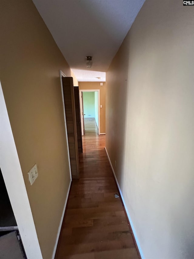 corridor with dark wood-type flooring