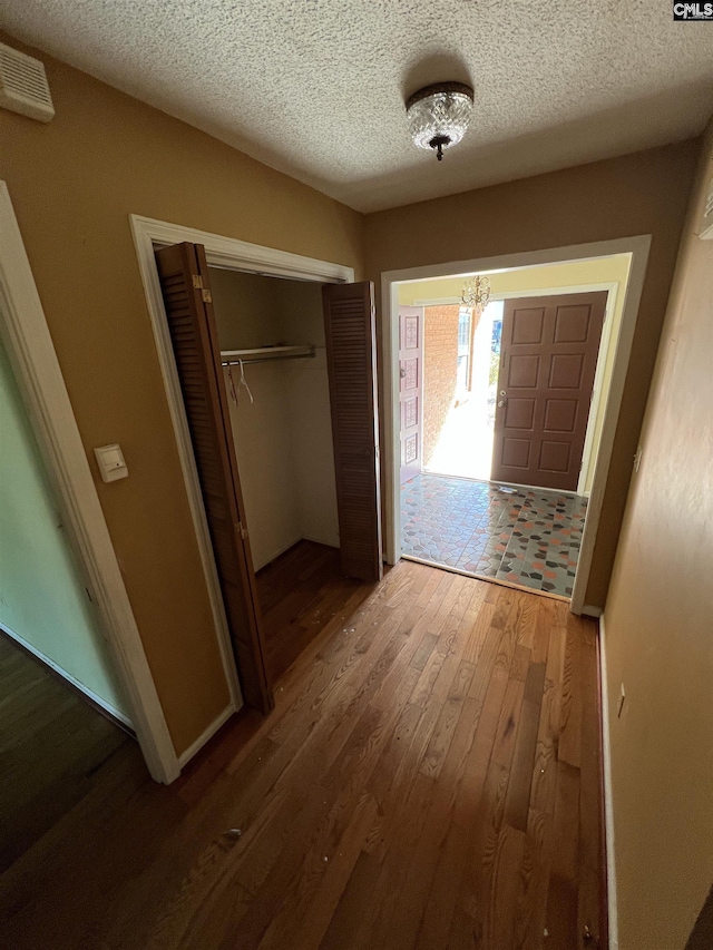 interior space with hardwood / wood-style floors and a textured ceiling