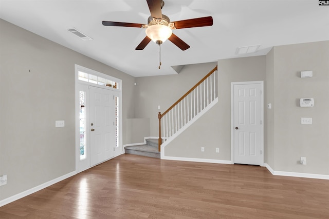 foyer with a wealth of natural light, light hardwood / wood-style floors, and ceiling fan