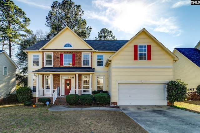 view of front of house with a front yard, a porch, and a garage