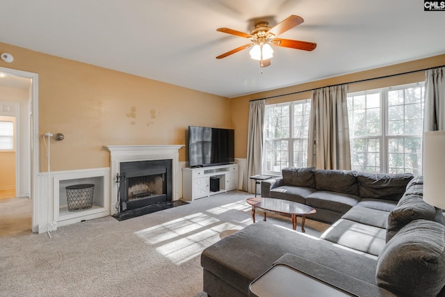 living room with ceiling fan and light colored carpet