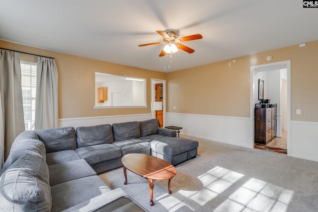 living room featuring ceiling fan and light carpet