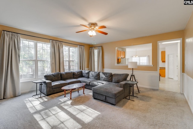 living room with light carpet, plenty of natural light, and ceiling fan