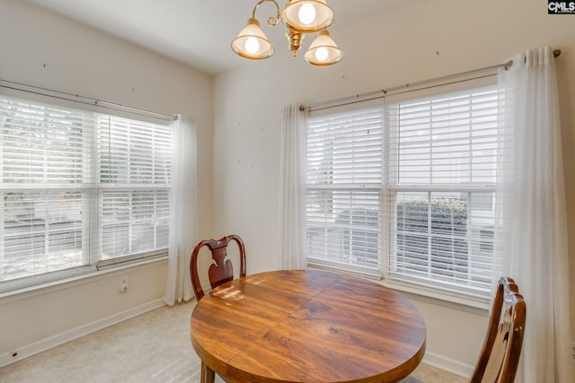 dining area featuring a notable chandelier