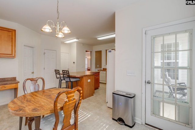 dining area with an inviting chandelier