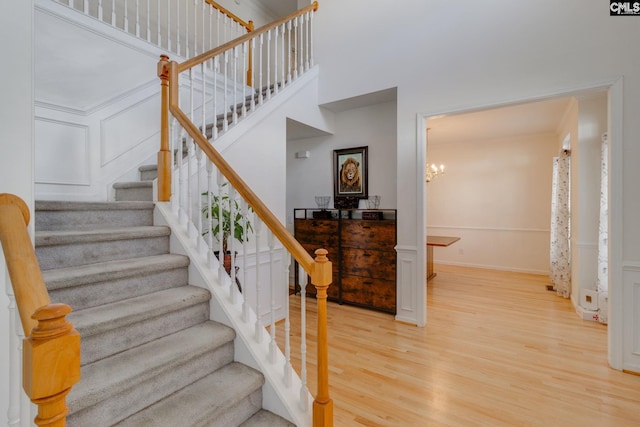 staircase featuring a chandelier and hardwood / wood-style flooring