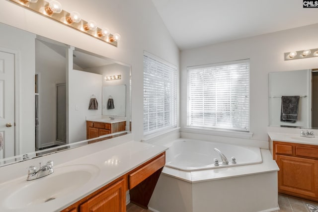 bathroom featuring vanity, vaulted ceiling, and shower with separate bathtub