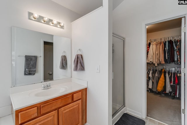 bathroom featuring vanity and an enclosed shower