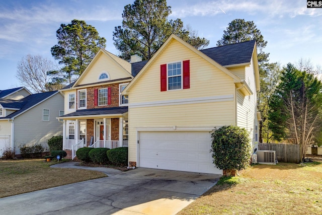 view of front of property with a front lawn, covered porch, central AC unit, and a garage