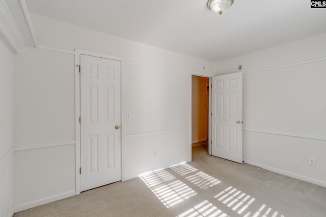 unfurnished bedroom with light colored carpet