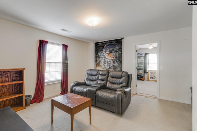 living room featuring ceiling fan and light colored carpet