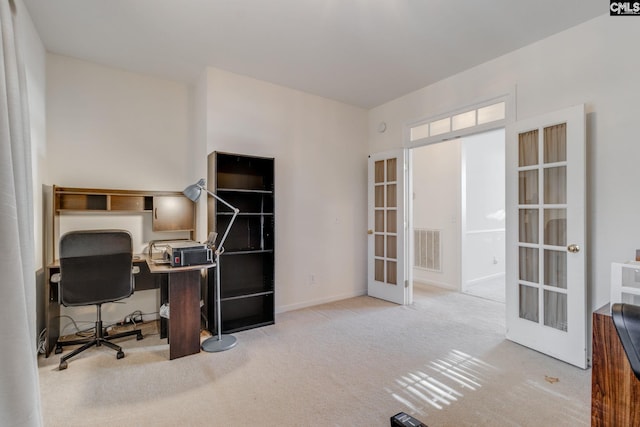 carpeted home office with french doors