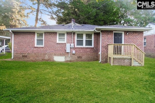 rear view of house with a lawn