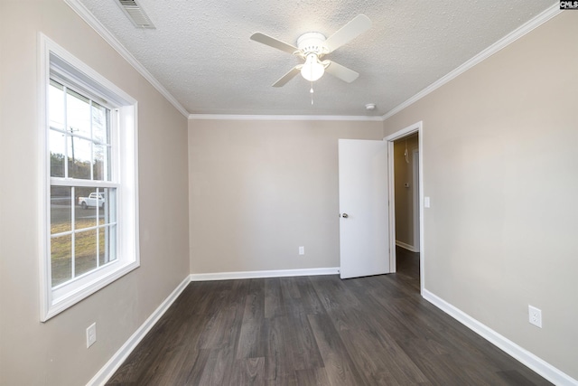 empty room with ceiling fan, dark wood-type flooring, a textured ceiling, and ornamental molding