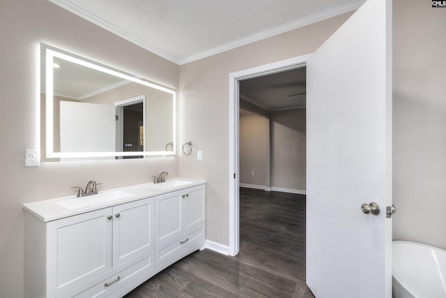 bathroom with wood-type flooring, vanity, and ornamental molding