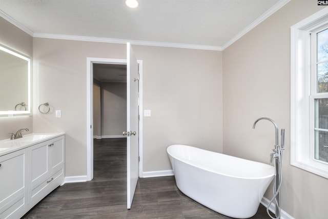 bathroom featuring vanity, wood-type flooring, a tub, and ornamental molding