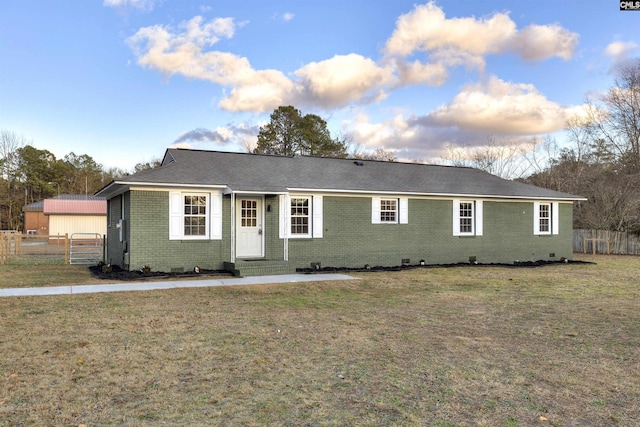 ranch-style home with a lawn