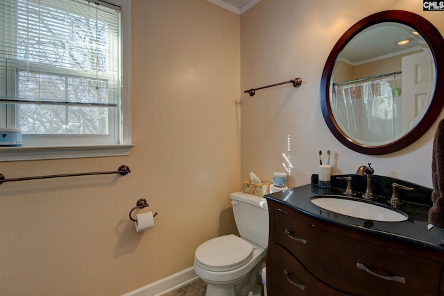 bathroom with vanity, toilet, and crown molding