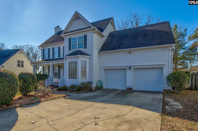 front facade with covered porch and a garage