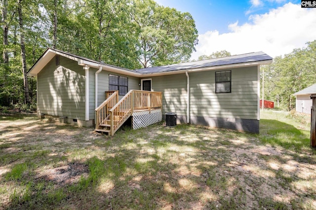 rear view of property featuring a wooden deck and cooling unit