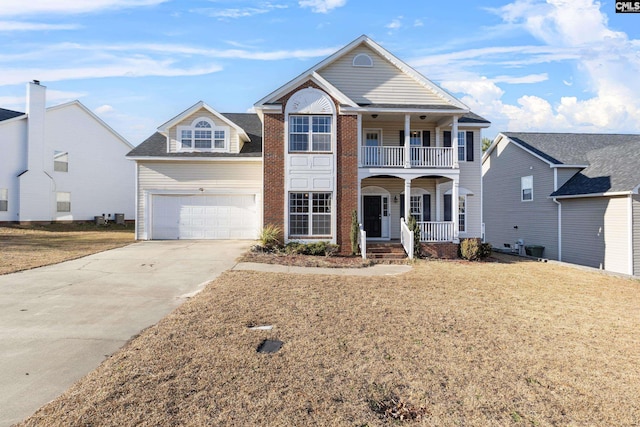 view of front of home featuring a porch, a garage, and a front lawn