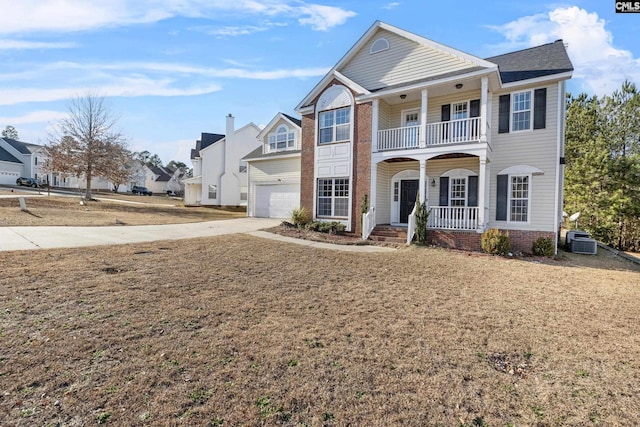 view of front of home featuring central air condition unit, a porch, and a garage