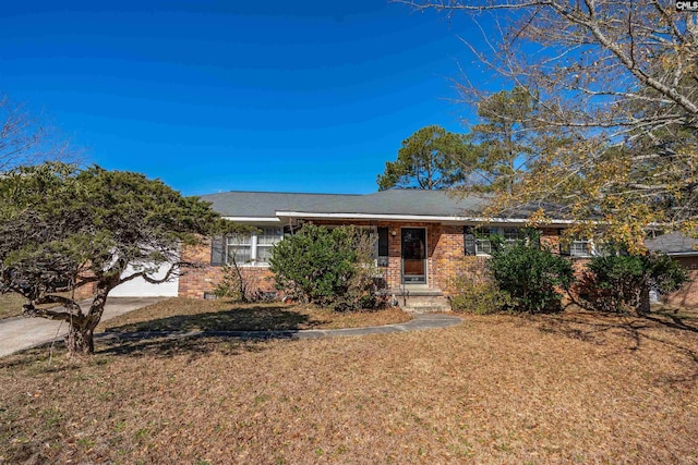 ranch-style home with a front yard and a garage