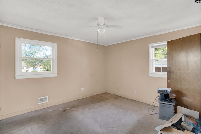 empty room featuring ceiling fan, ornamental molding, and a textured ceiling