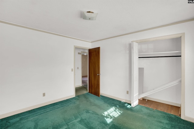 unfurnished bedroom featuring ornamental molding, carpet floors, and a closet