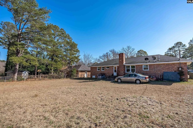 rear view of property featuring a lawn