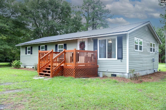 view of front of property with a front yard and a deck