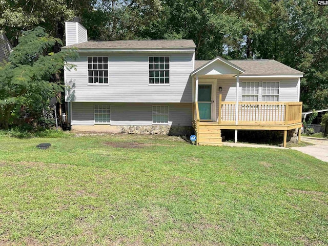 split level home featuring a front lawn and a deck