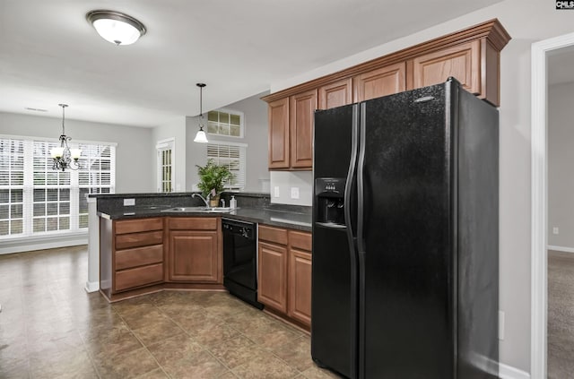 kitchen featuring black appliances, a notable chandelier, sink, and hanging light fixtures