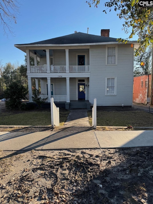 back of house with a balcony