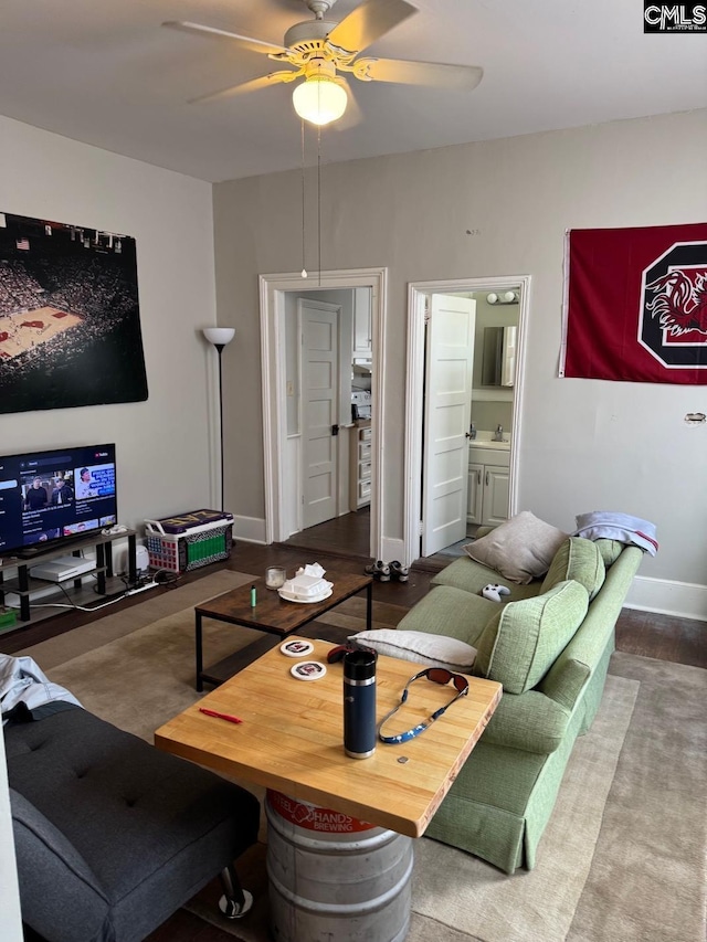 living room with ceiling fan and sink