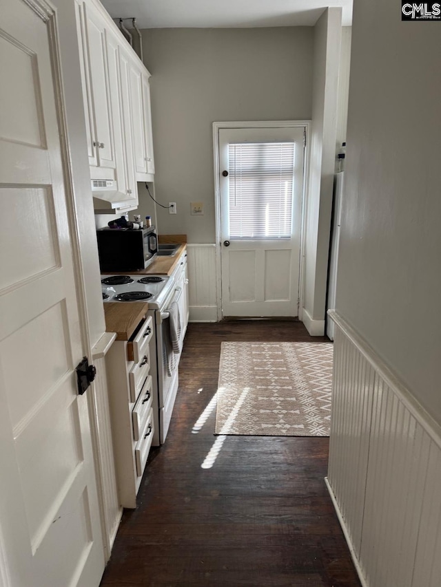 kitchen with wood counters, stove, ventilation hood, white cabinets, and dark hardwood / wood-style floors