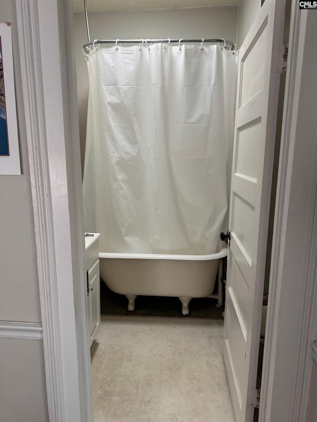 bathroom featuring vanity and shower / bath combination with curtain