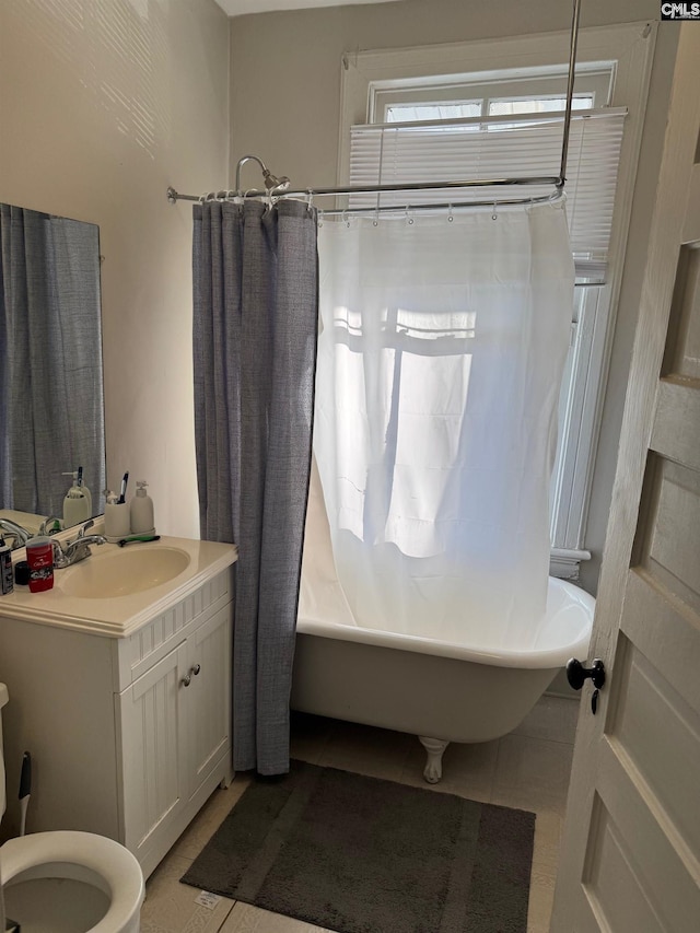 full bathroom featuring toilet, vanity, tile patterned floors, and shower / bathtub combination with curtain