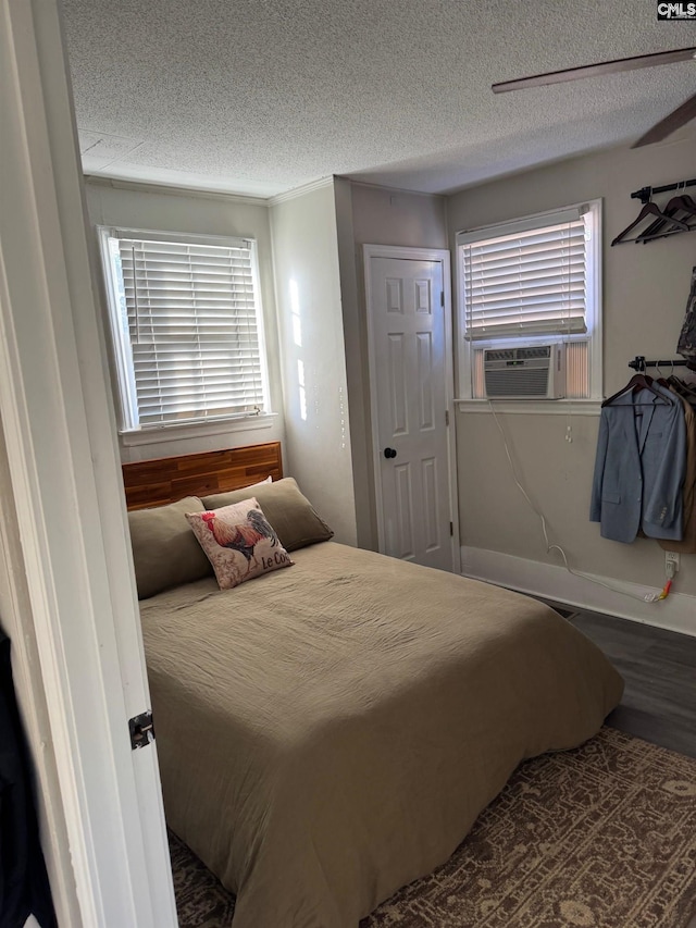 bedroom with a textured ceiling and cooling unit