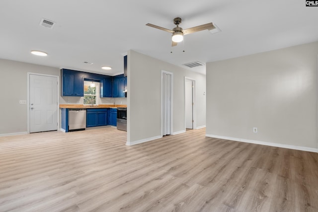 unfurnished living room featuring ceiling fan, light wood-type flooring, and sink